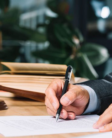 An advocate signing a document